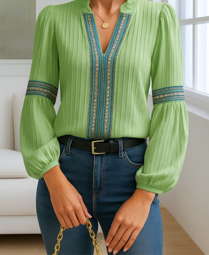 Female styled in a vintage-inspired blouse on a plain background.