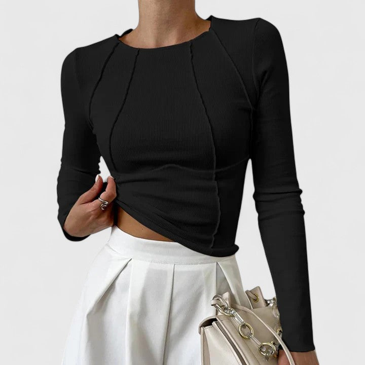 Woman modeling a soft tailored top on a clean background.