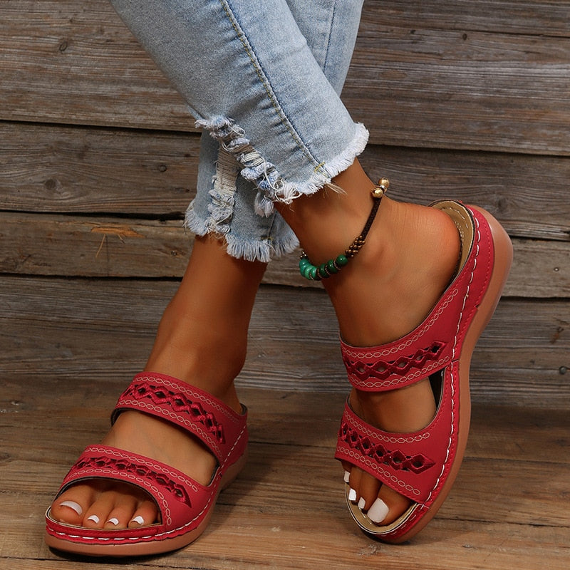 Front view sandals worn by model on gray wooden background