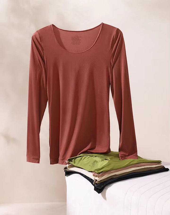 Matching base layer top and leggings on a plain background.