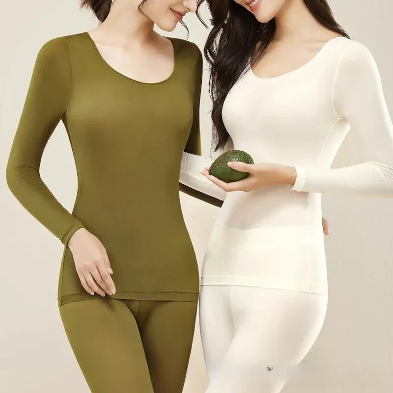 Woman wearing a round neck thermal set with leggings on a plain background.