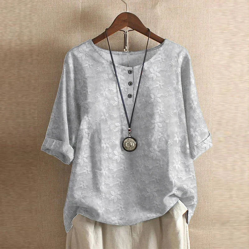 White round neck printed blouse on wooden hanger