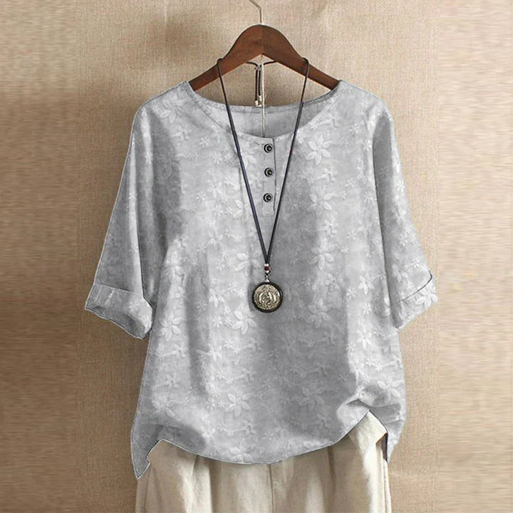 White round neck printed blouse on wooden hanger