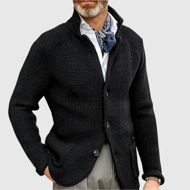  Man wearing a coordinated blazer and trousers with a soft structured look on a plain background.