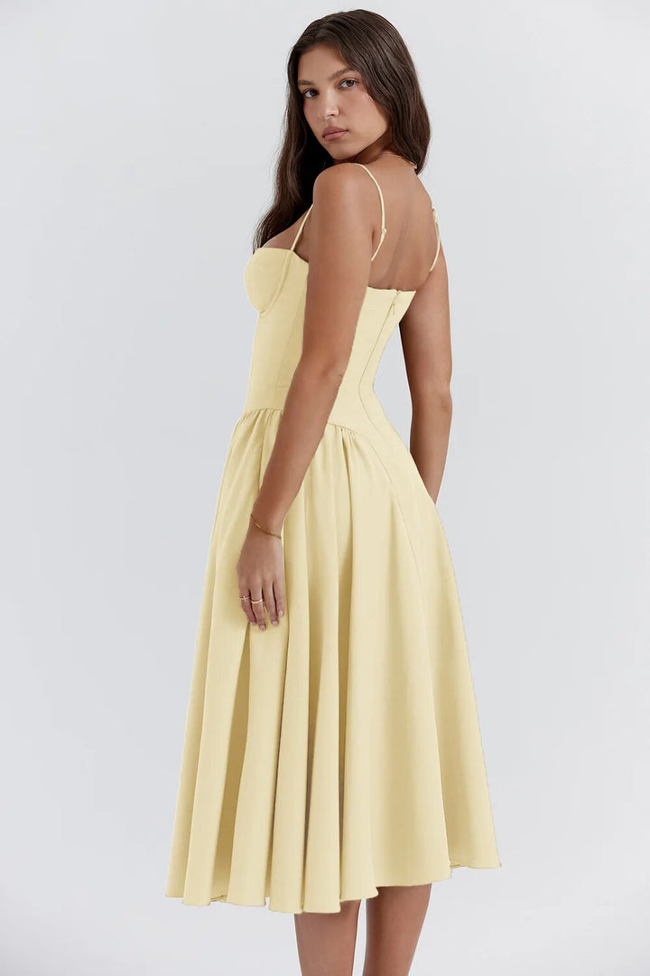 Woman wearing a soft fabric midi dress on a plain background
