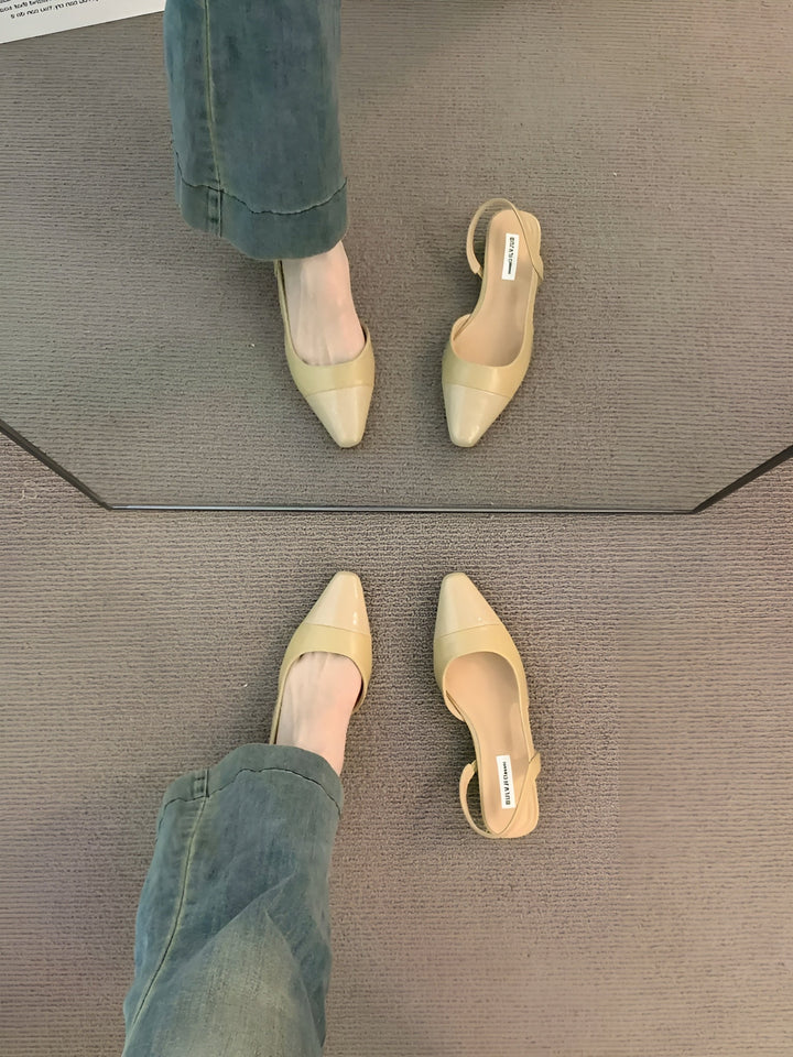 Front angle of sandal emphasizing pointed design plain background
