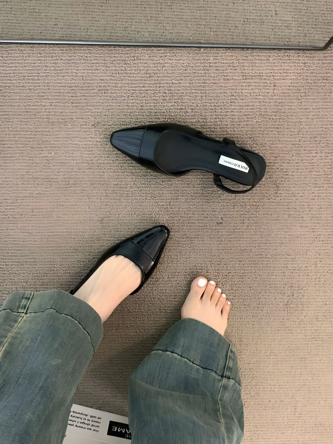 Foot model relaxed stance showing shoe fit plain background