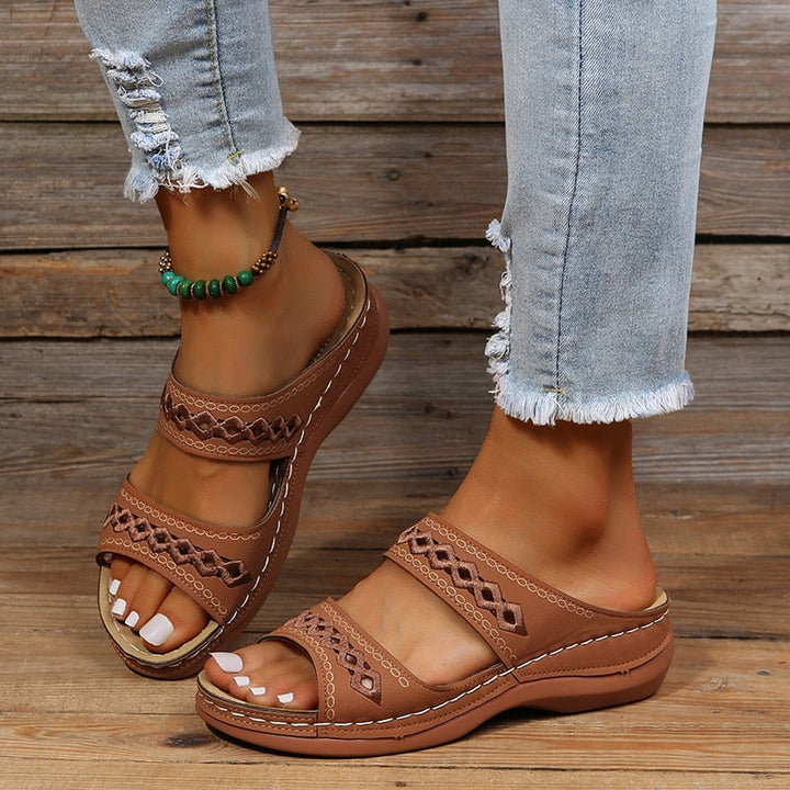 Walking pose sandals worn by foot model wooden floor shot