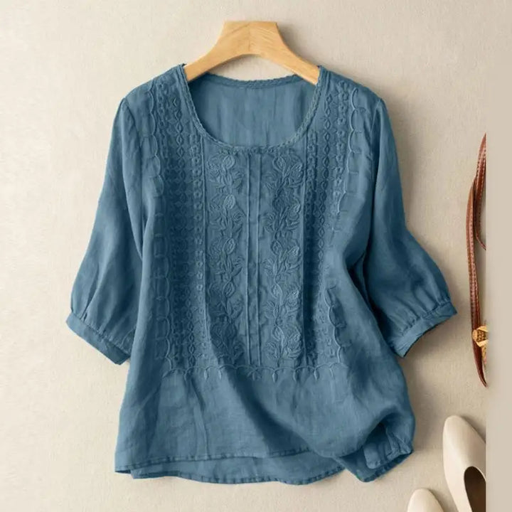 Lightweight embroidered blouse with relaxed fit on a clean background.