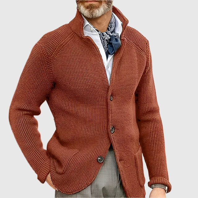  Man showcasing a clean two-piece suit with casual tailoring on a plain background.
