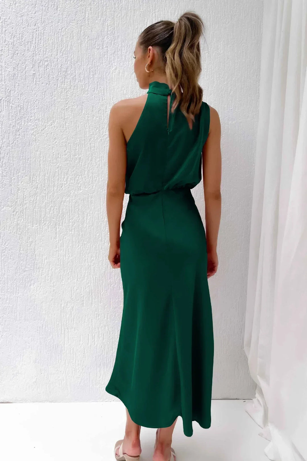 Satin evening dress with a modern silhouette shown on a female model.