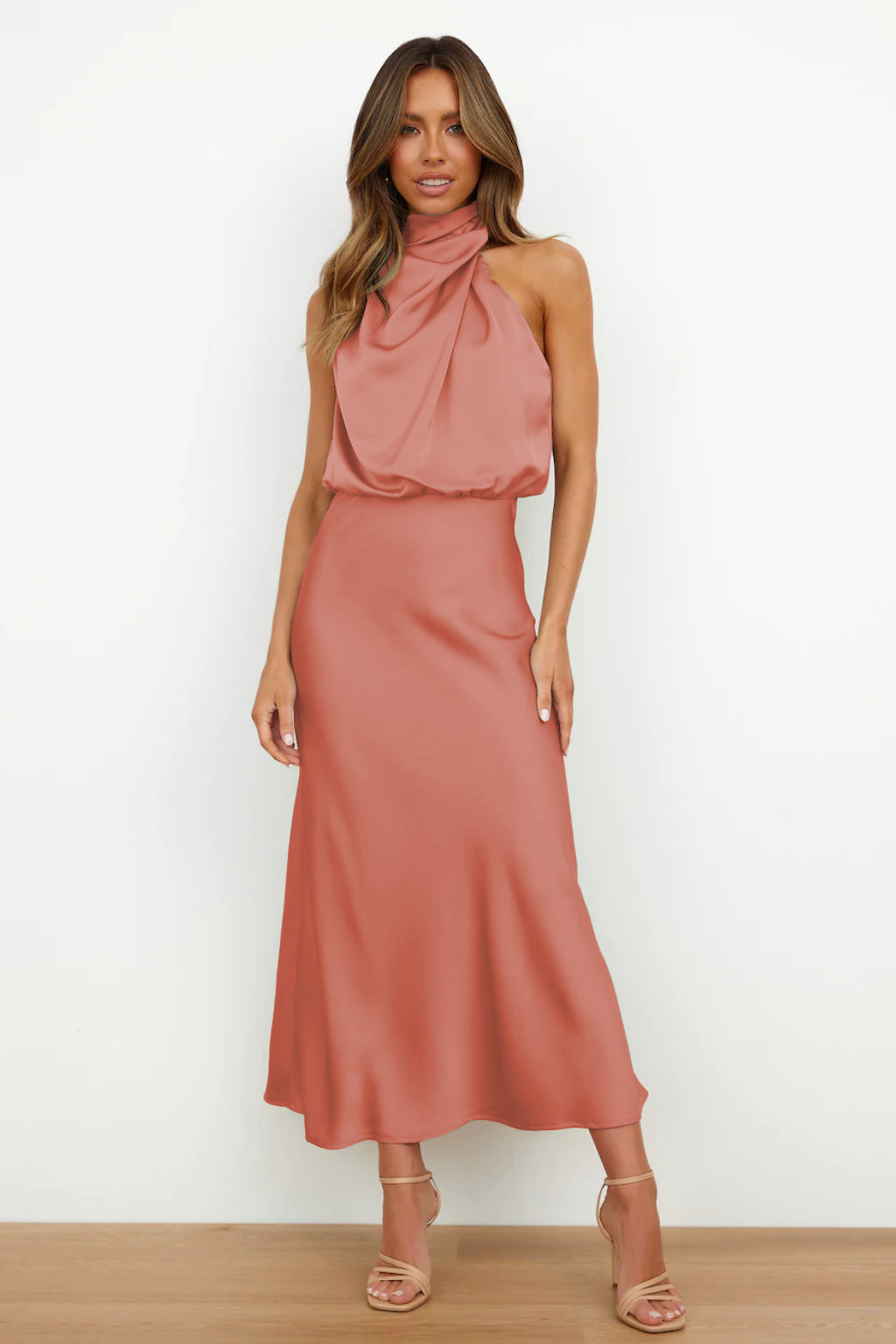 Female wearing a long satin gown with a soft shine and clean finish.