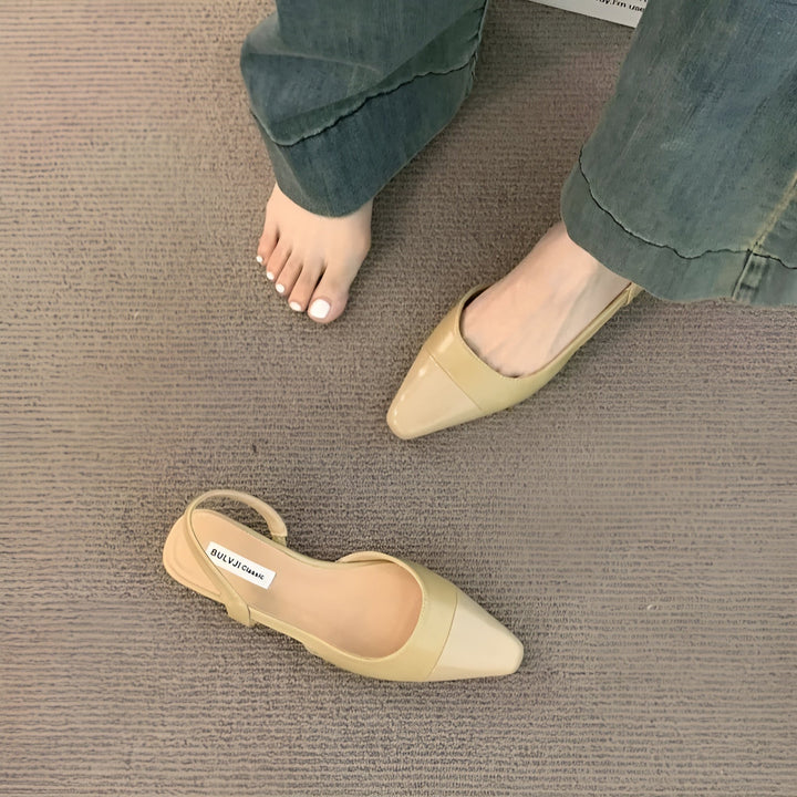 Foot model angled front showing pointed toe plain background