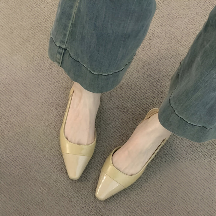 Minimalist shot of foot wearing flats plain background aesthetic