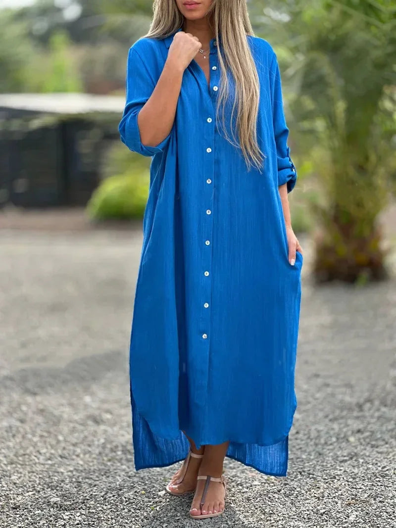 Female model posing in a casual maxi shirt dress with a simple clean backdrop.