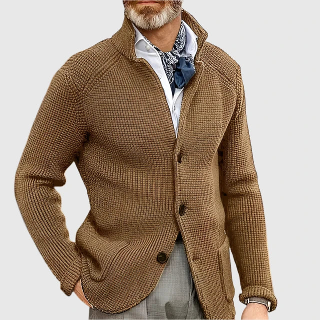 
Male model wearing a lightweight blazer and trouser set on a plain background.