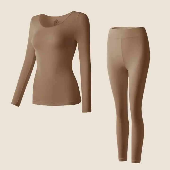 Fitted thermal top and slim leggings on a plain background.