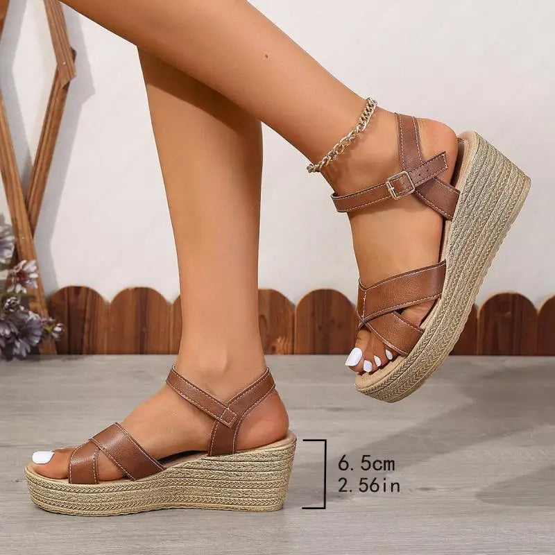 Foot model standing wearing casual wedge sandals plain background