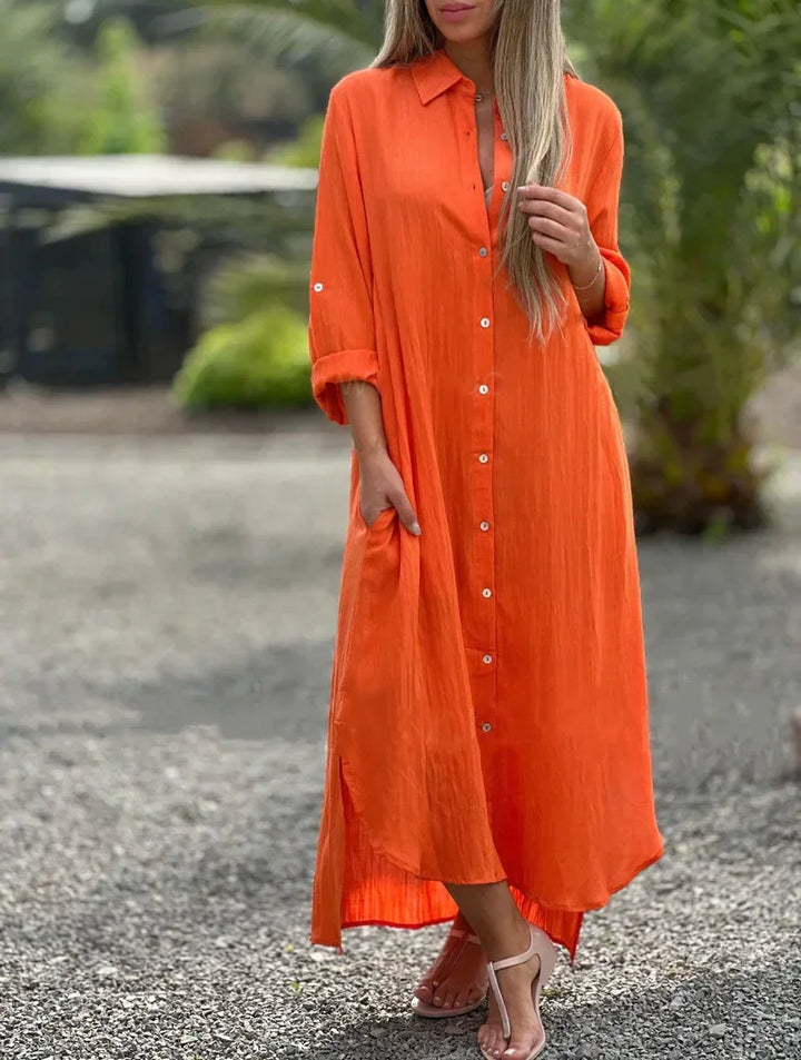 Woman showcasing a long button-down maxi dress with a minimalist background