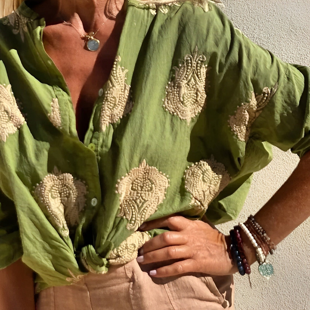 Female model turning wearing airy blouse side angle plain background