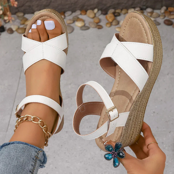 Foot model front view in wedge sandals nature background clean