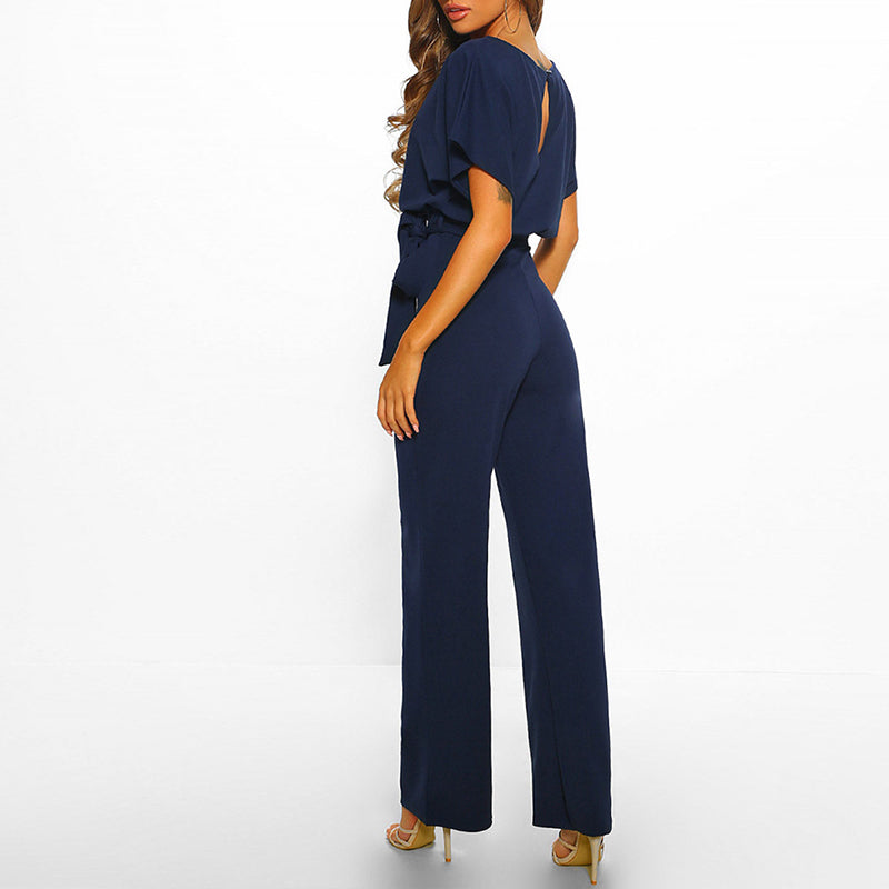 Model posing front view wearing elegant wide leg outfit plain background