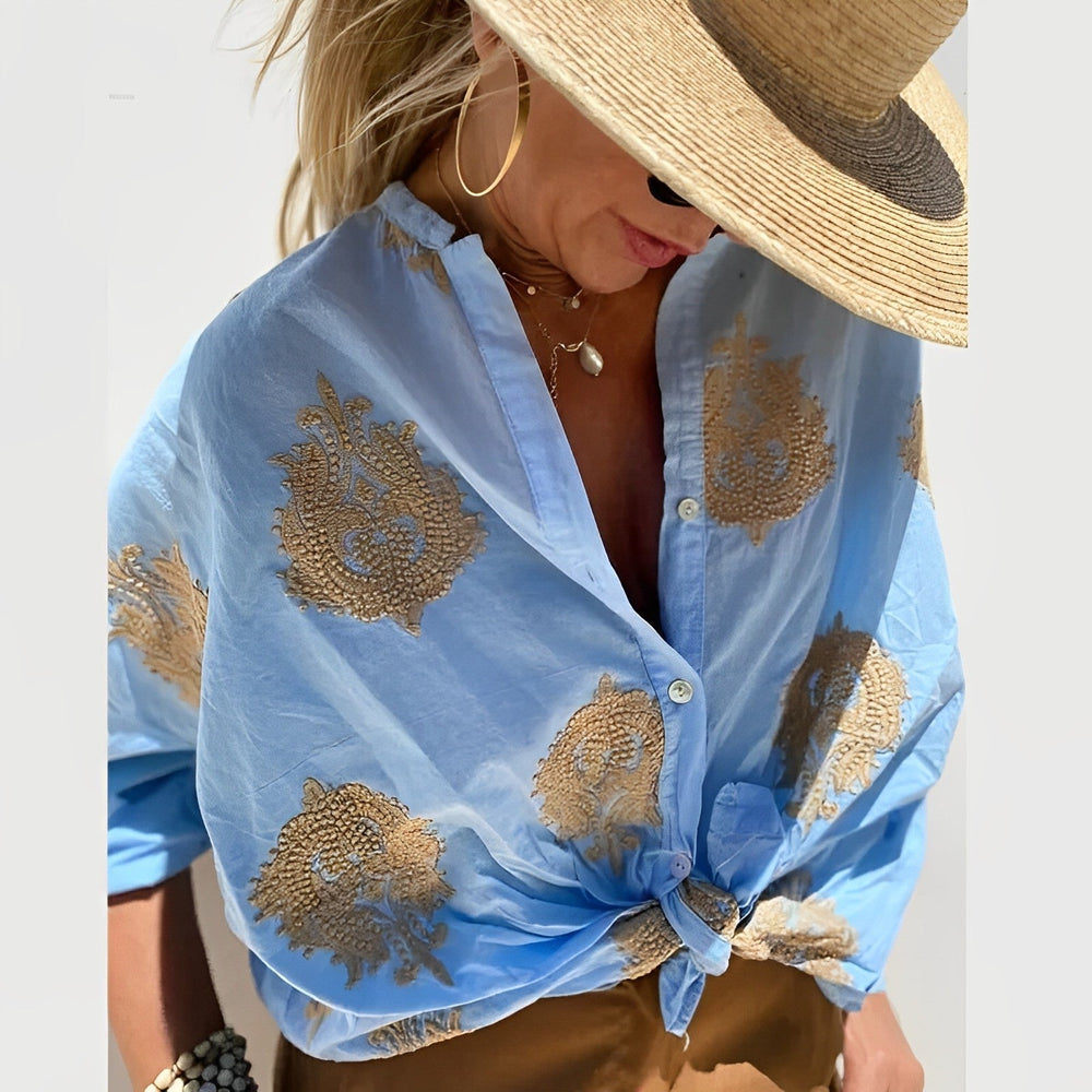 Woman posing in airy summer blouse loose fit plain background