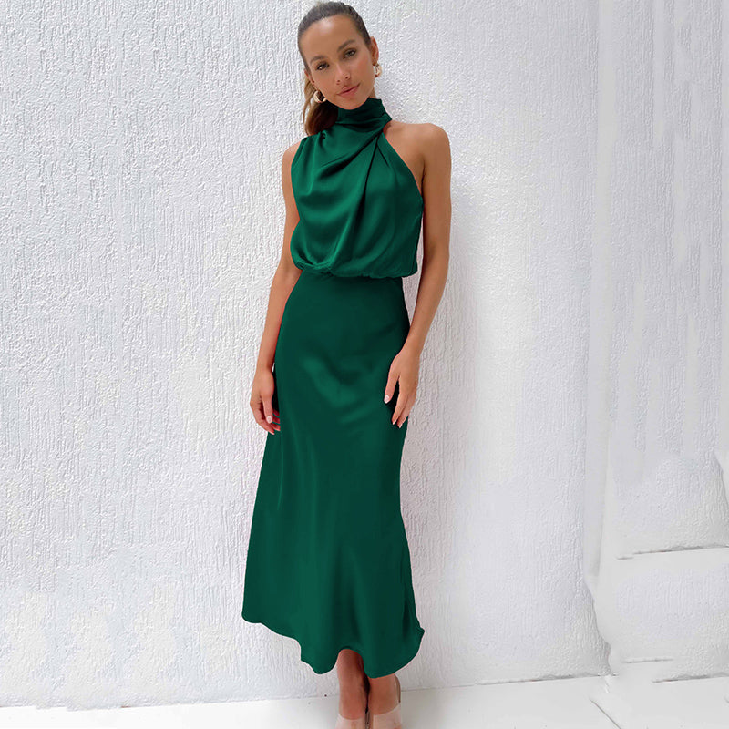Woman posing in a formal satin dress with a flowing hemline.
