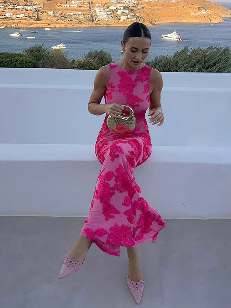 Full-length dress hanging from hanger against plain background.