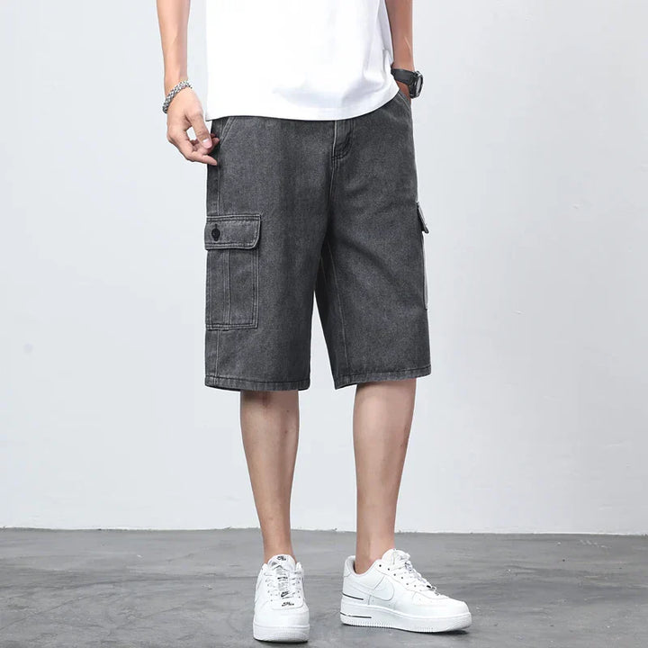  Model in relaxed casual cargo shorts with utility pocket detail on a plain background.