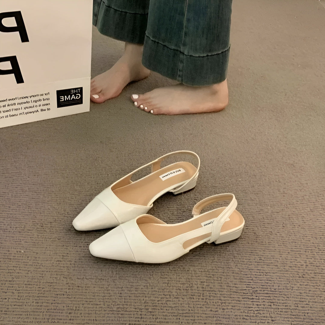 Slight side angle showing sleek silhouette plain background foot