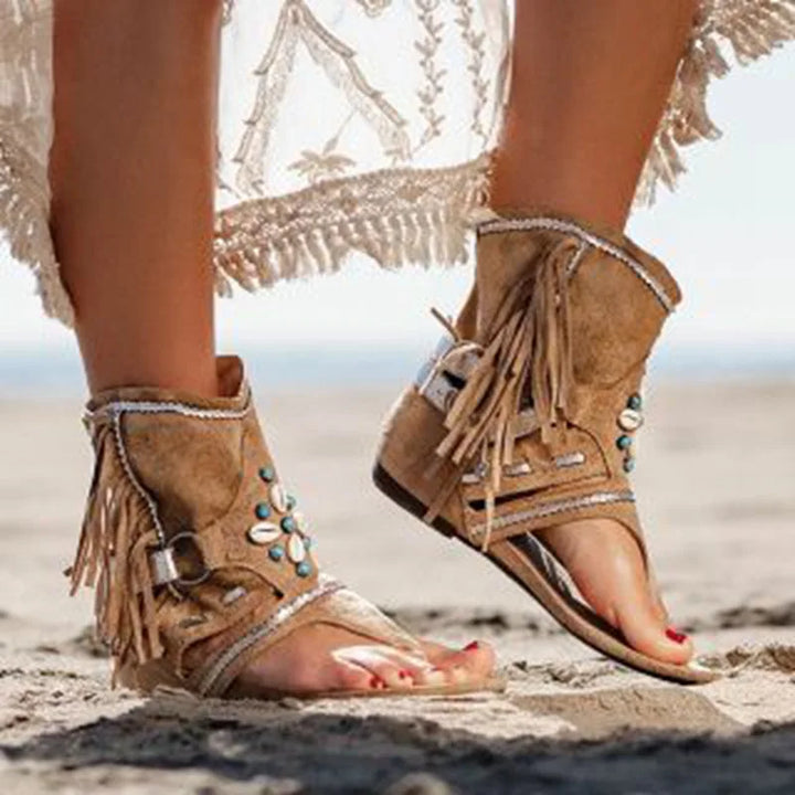 Front top angle foot in stylish sandals plain background