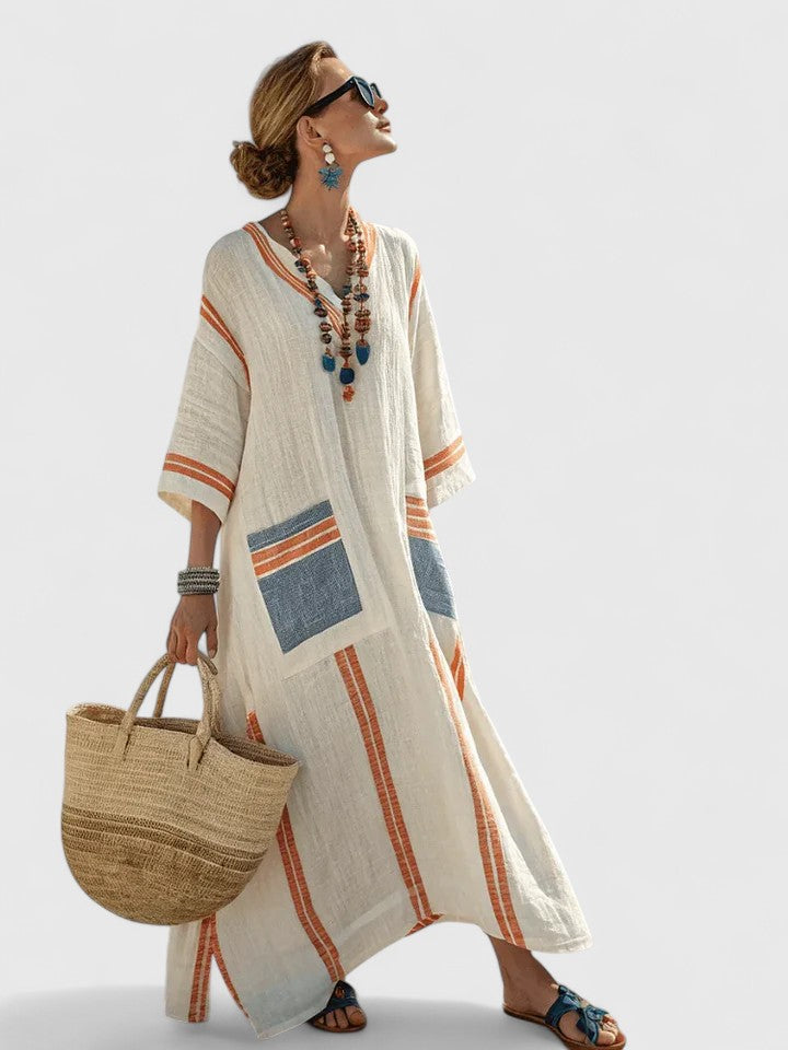 Model in a summer striped kaftan maxi dress against a plain background.