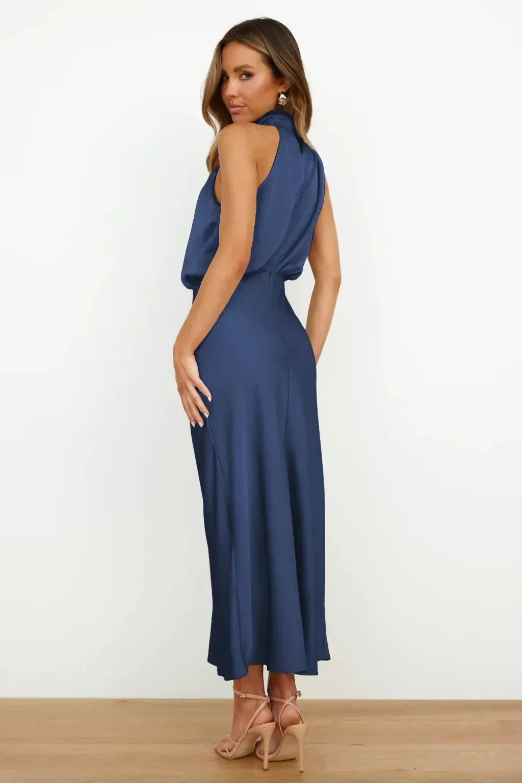 Model wearing a halter style dress designed for special occasions on a plain background.
