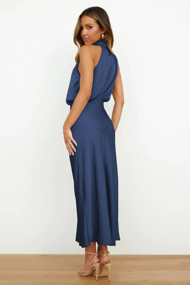 Model wearing a halter style dress designed for special occasions on a plain background.