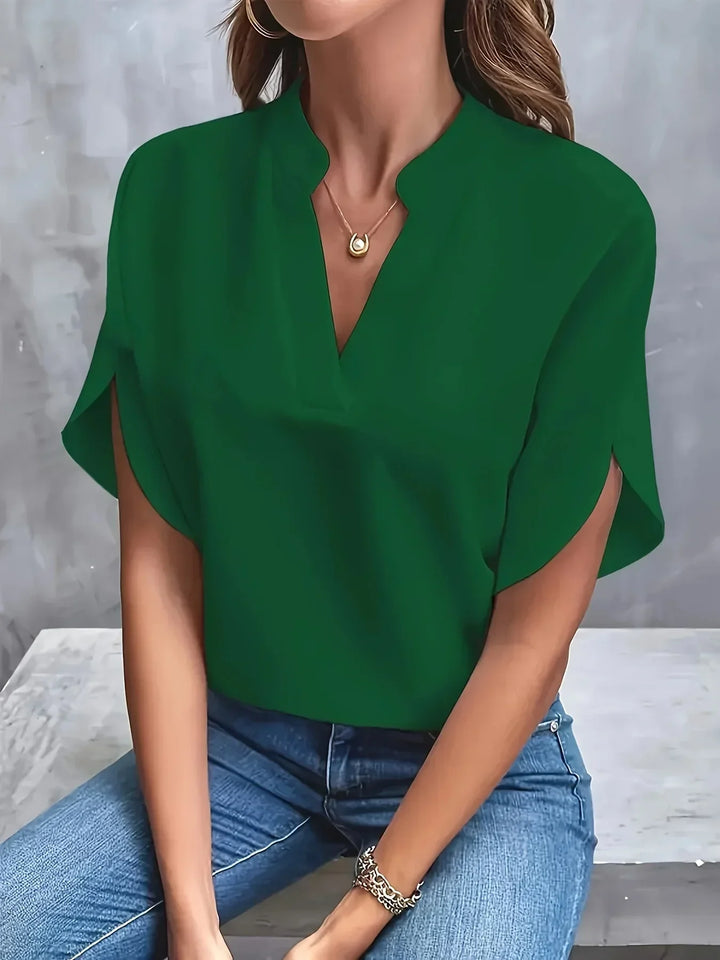 Model wearing a versatile summer blouse for casual outfits on a clean background.