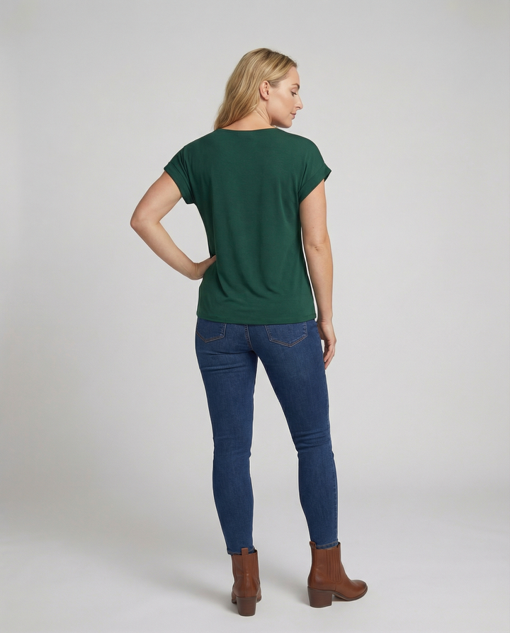 Female model in an elegant short sleeve blouse with a flattering V-neck design.