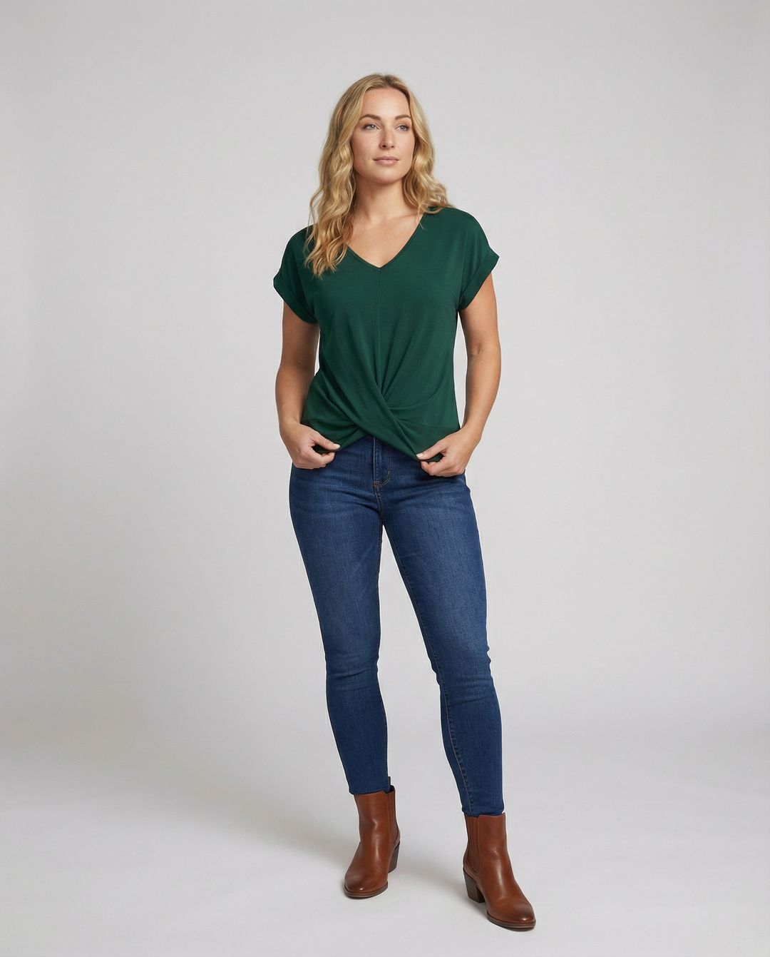 Female model wearing a V-neck short sleeve blouse against a plain background.