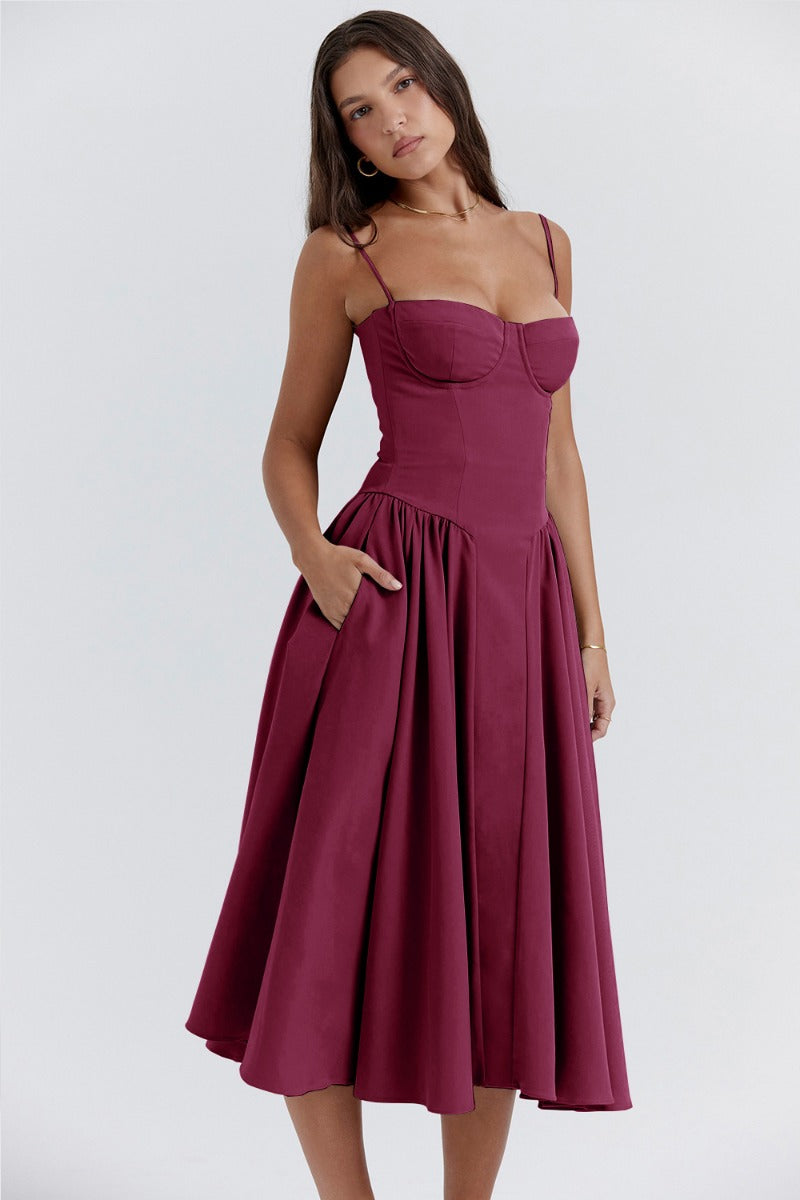 Woman showcasing a flattering waistline dress on a plain background
