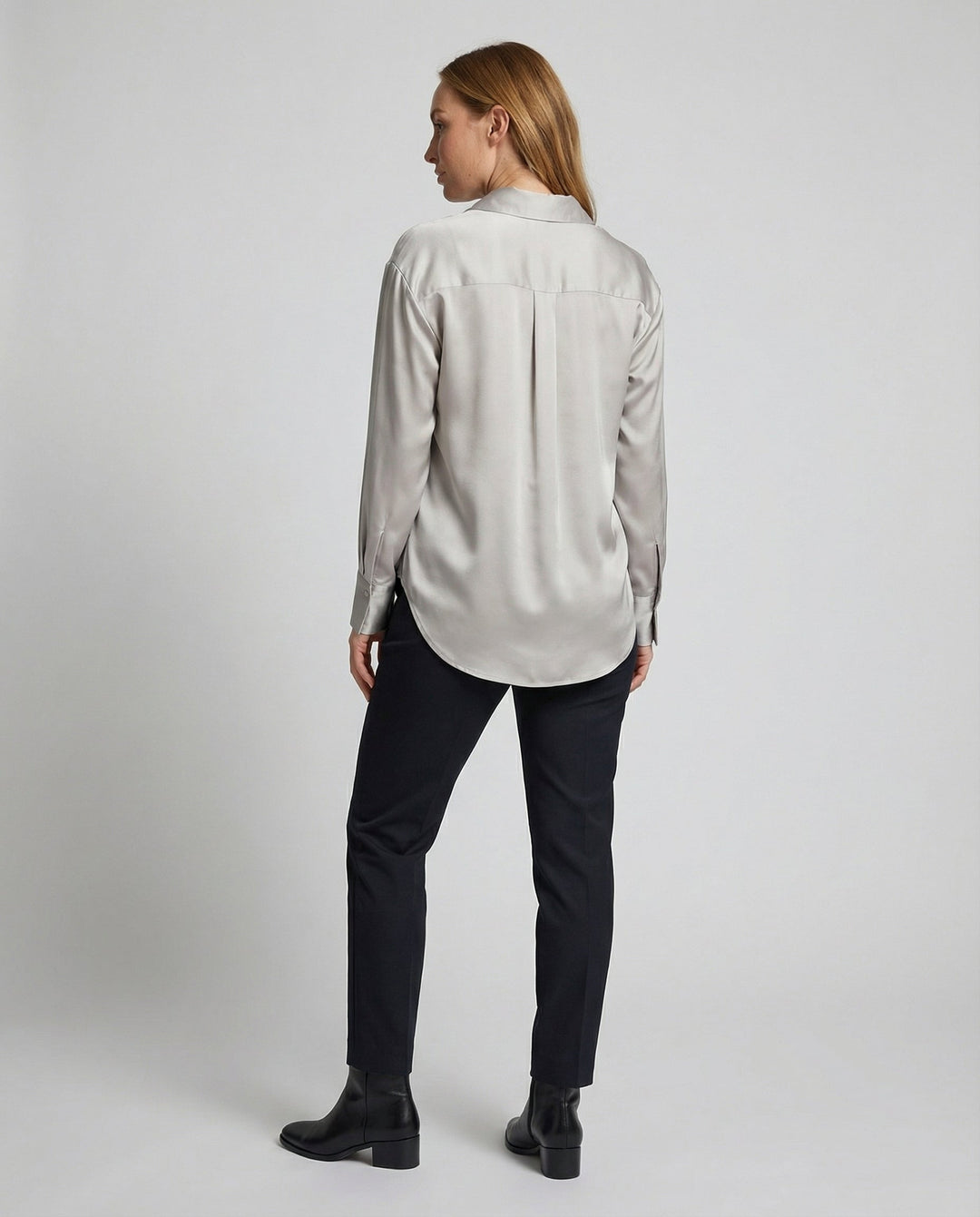 Woman wearing a smooth vintage-inspired blouse against a plain background.
