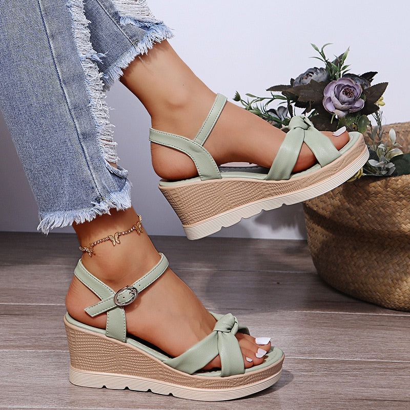 Close-up of toe area straps on foot model plain background