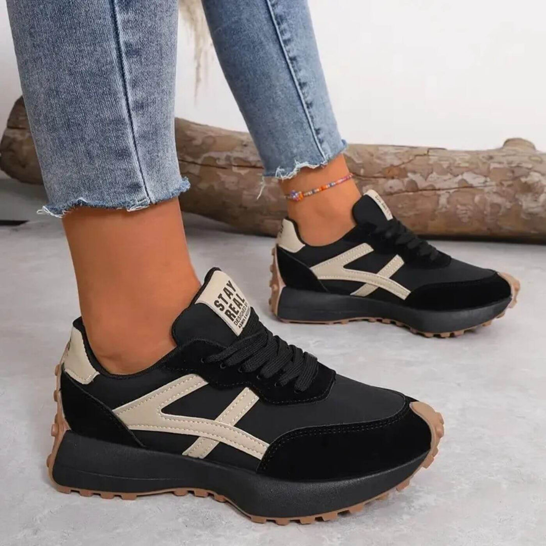 Black running sneakers with beige side stripe detail