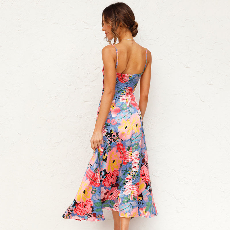 Woman in flowing floral dress with sleeveless look, plain background, backview