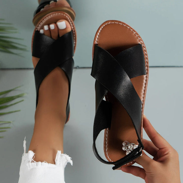 Woman model wearing sandals front view plain background studio lighting