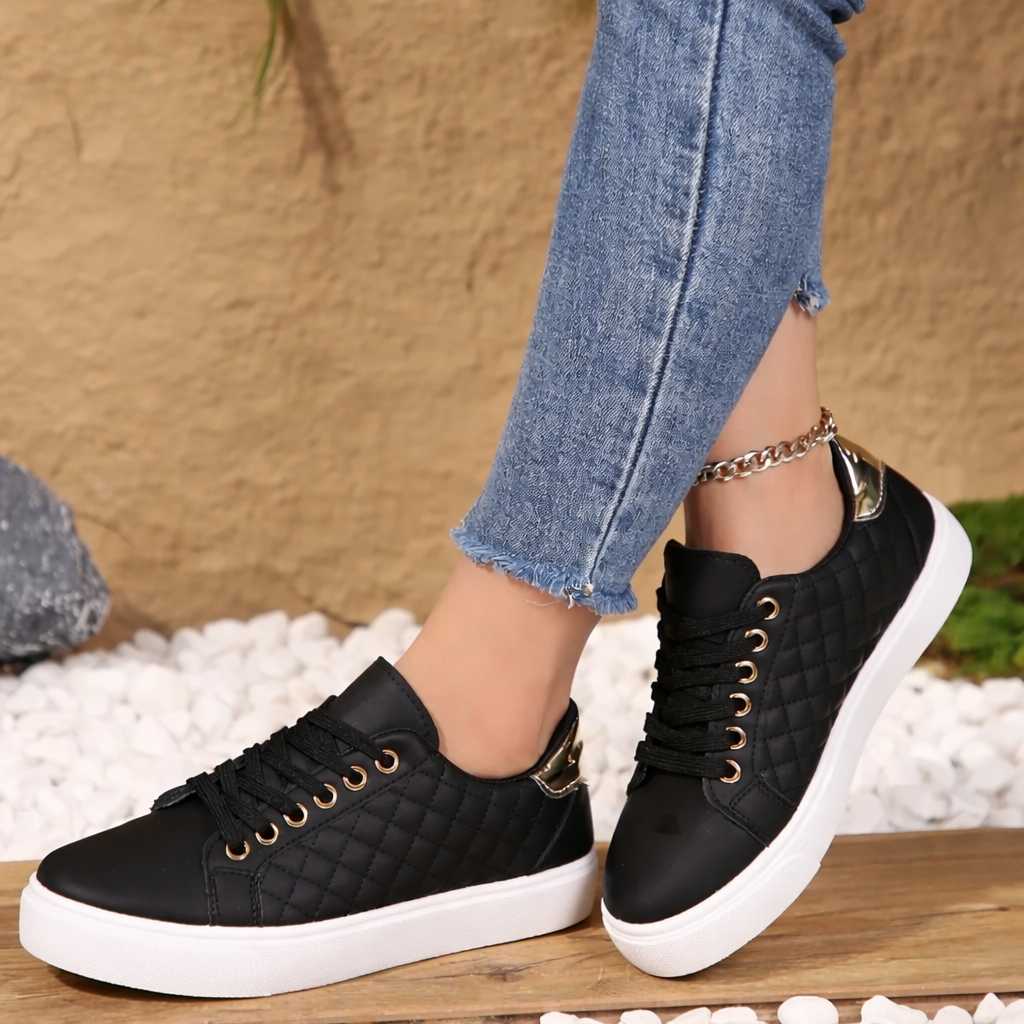 Side angle black casual sneakers on outdoor pavement