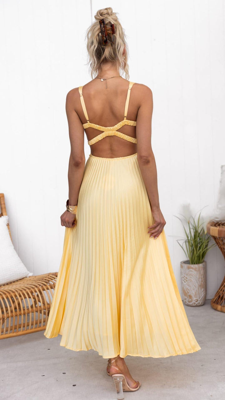 Woman modeling a flowy midi dress with soft pleats.
