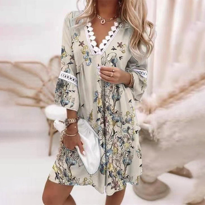  Female model showcasing a boho-inspired mini dress against a plain background.