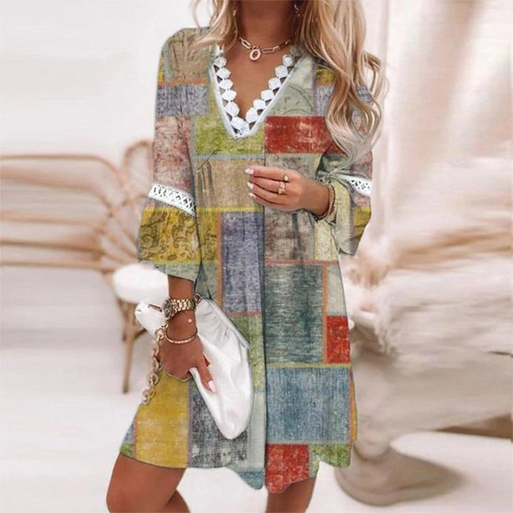  Woman in a feminine printed mini dress with casual styling on a plain background.
