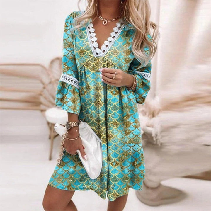  Model wearing a breezy boho mini dress with playful print on a plain background.