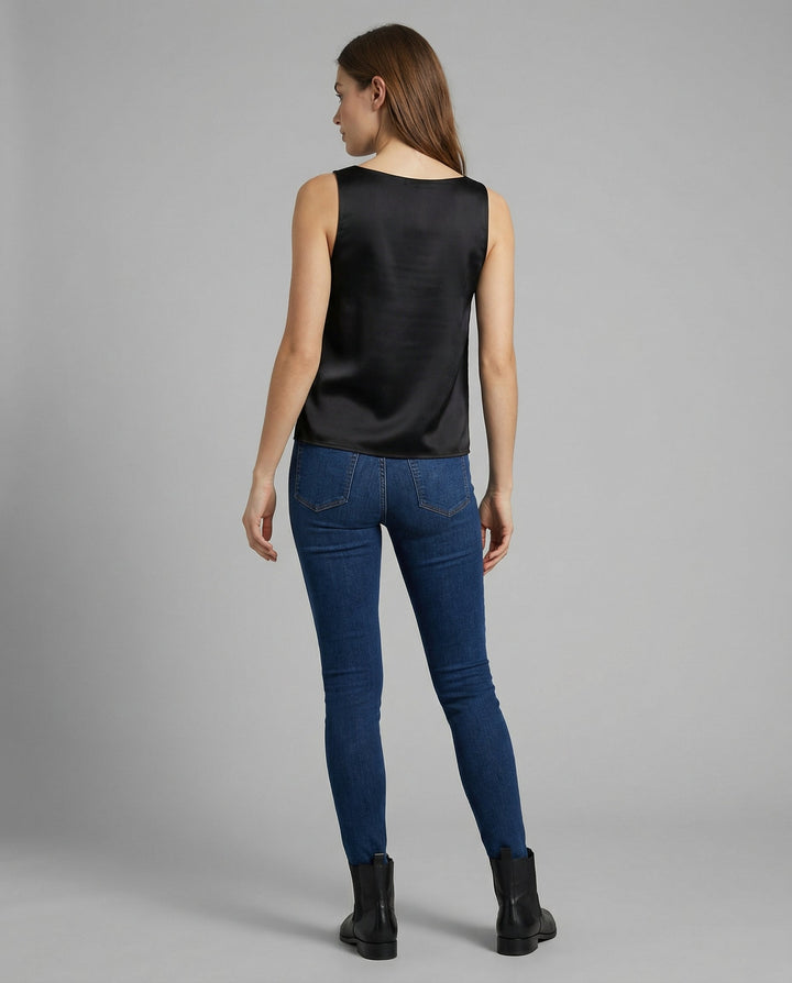 Female model in a simple sleeveless top styled against a plain backdrop.